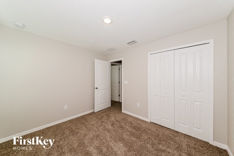 A room with a carpeted floor and white walls.