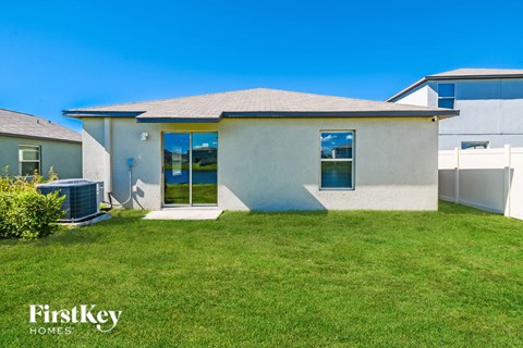 A house with a lawn in front of it is for sale by FirstKey Homes.