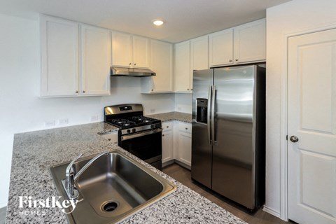 a kitchen with stainless steel appliances and granite counter tops