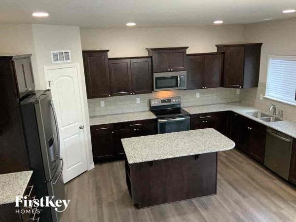 a kitchen with brown cabinets and a white counter top