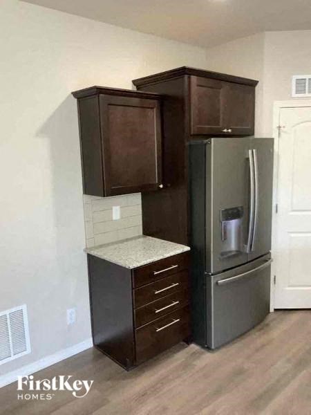 a kitchen with a stainless steel refrigerator and
