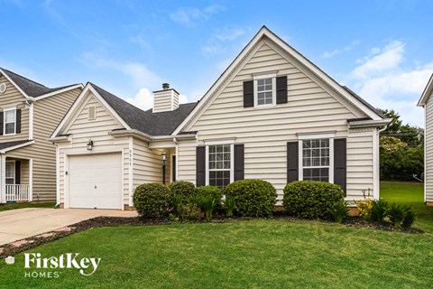 a home with a lawn and a garage