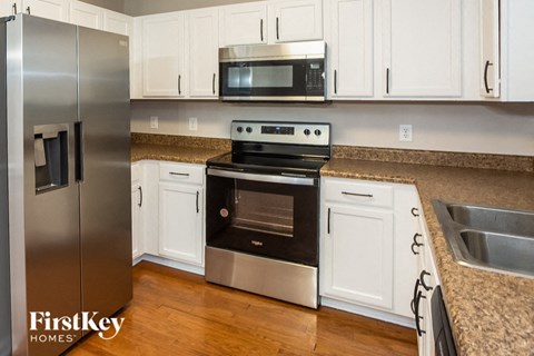a kitchen with stainless steel appliances and white cabinets