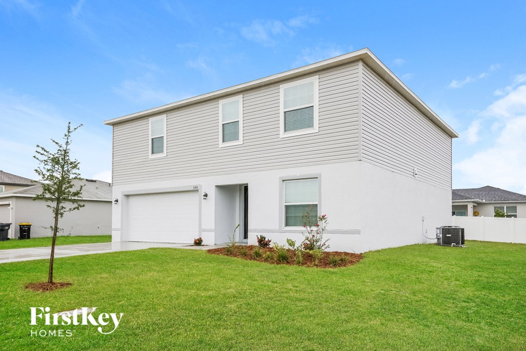a white house with a lawn in front of it