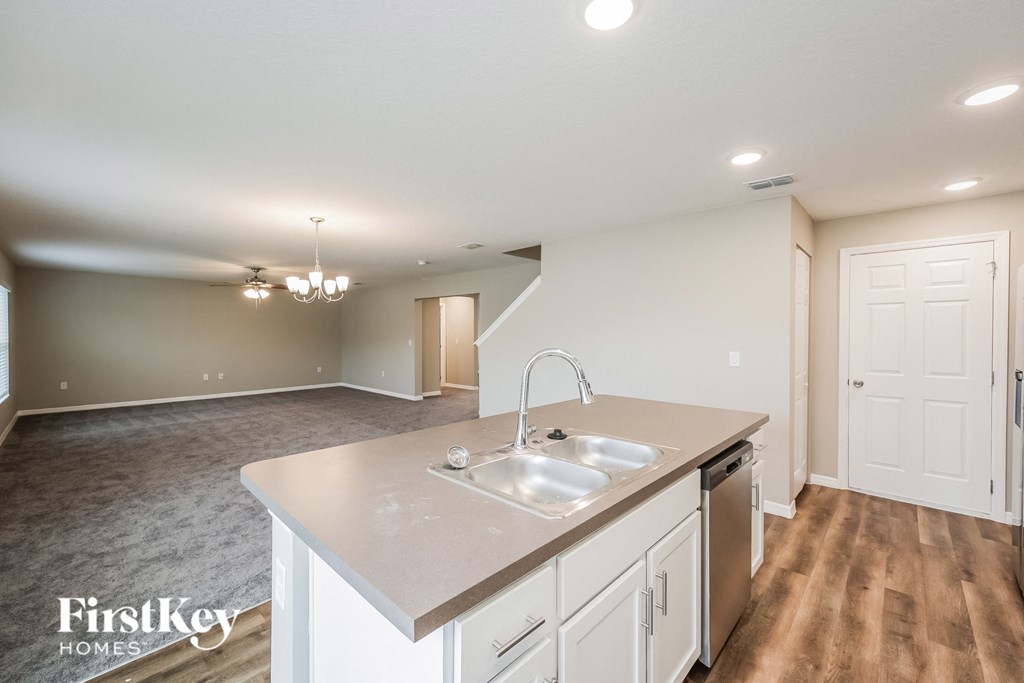 the kitchen is open to the living room and dining room