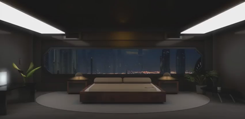 a bedroom with a bed and a view of a city at night