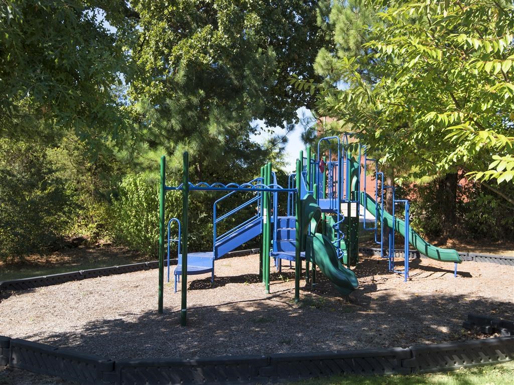a playground with a slide in a park
