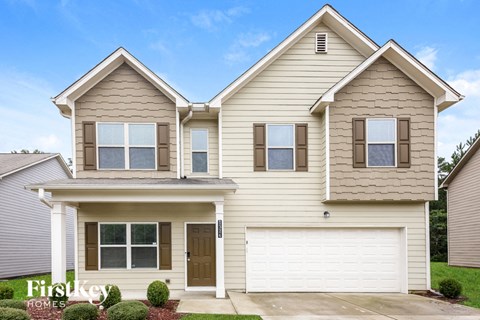 a beige house with a white garage door