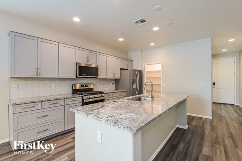 A kitchen with granite countertops and stainless steel appliances.
