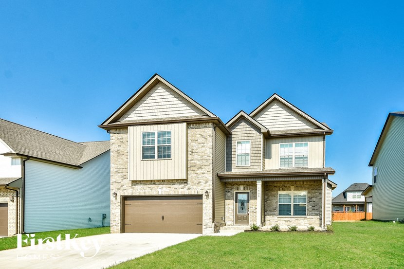 a large house with a garage door in front of it
