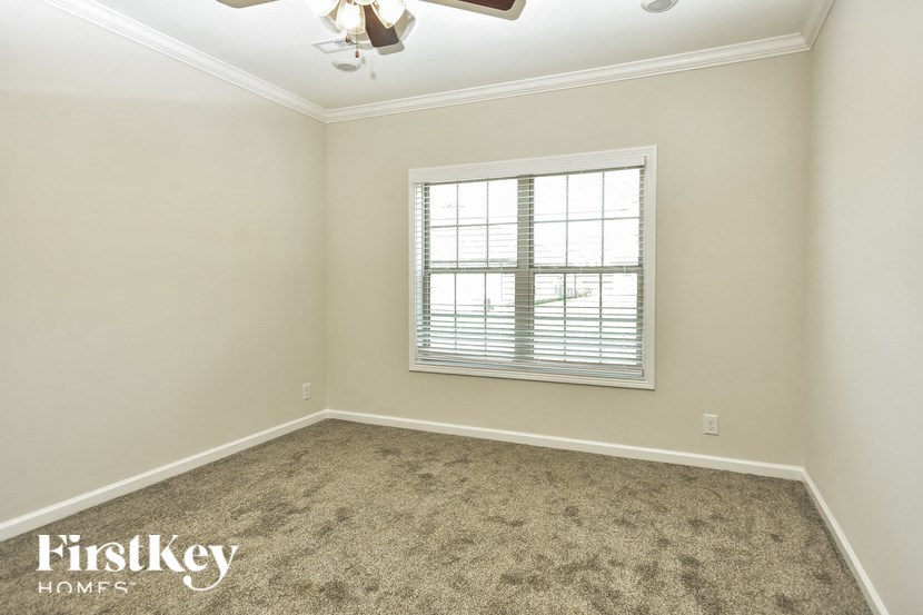 a empty room with a window and a carpet