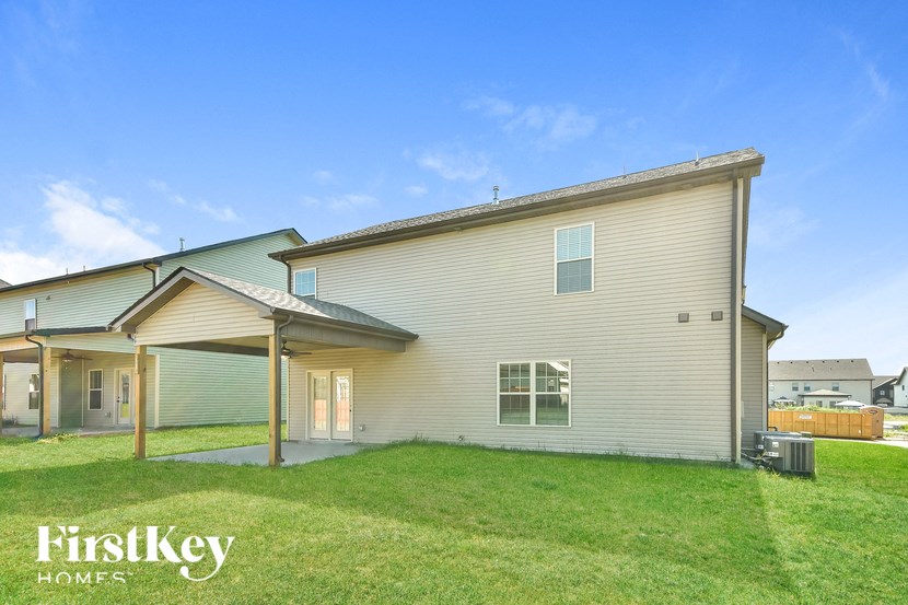 the outside of a house with a lawn and a porch