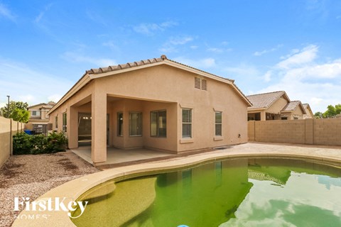 a house with a pool in front of it