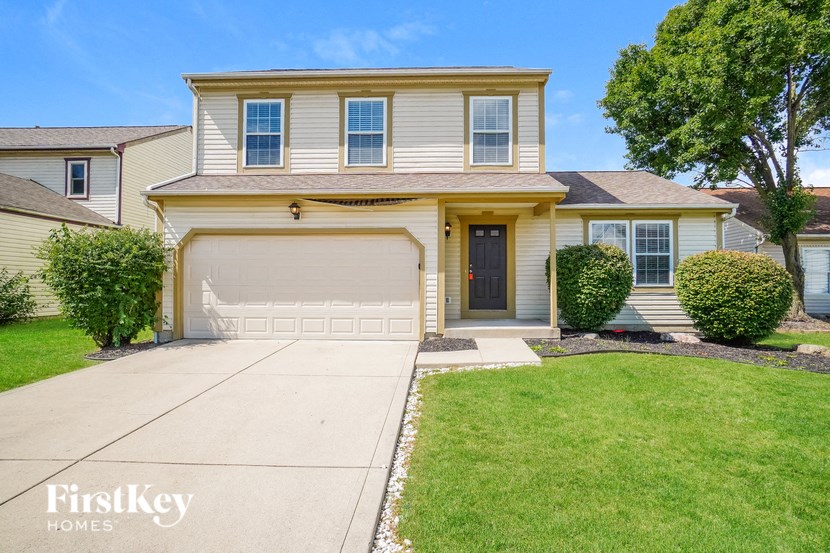 A two-story house with a garage is for sale.