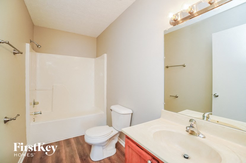A white toilet sits next to a sink in a small bathroom.