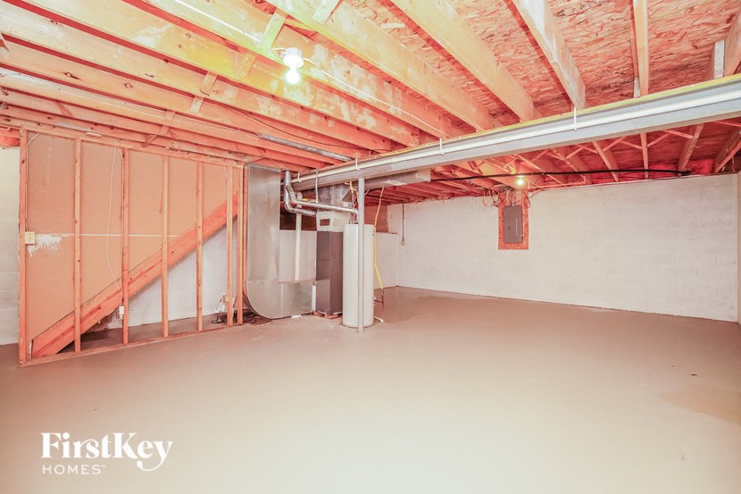 A room under construction with a FirstKey Homes logo.