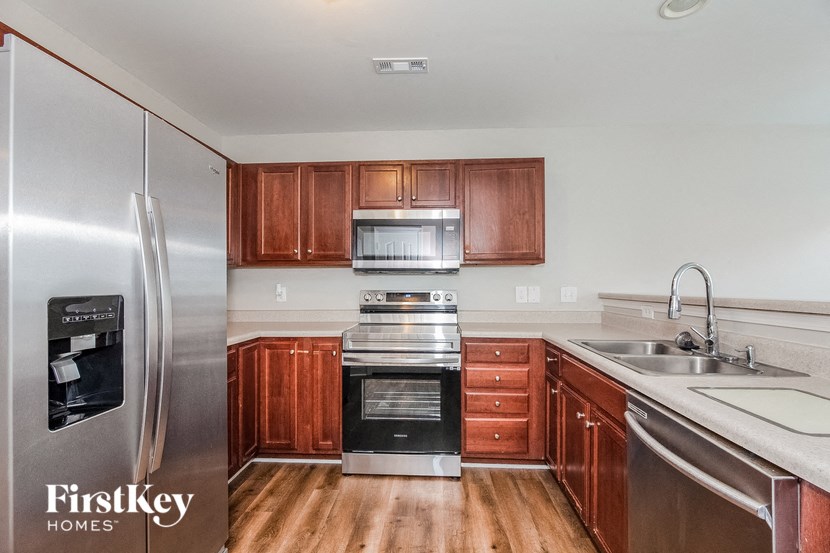 a kitchen with stainless steel appliances and wooden cabinets