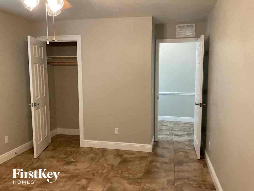 A room with a tile floor and a white door.