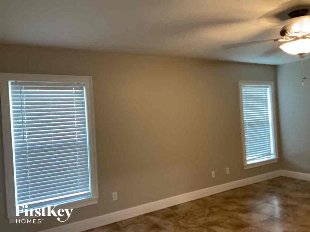 A room with a FirstKey Homes logo on the bottom left corner.