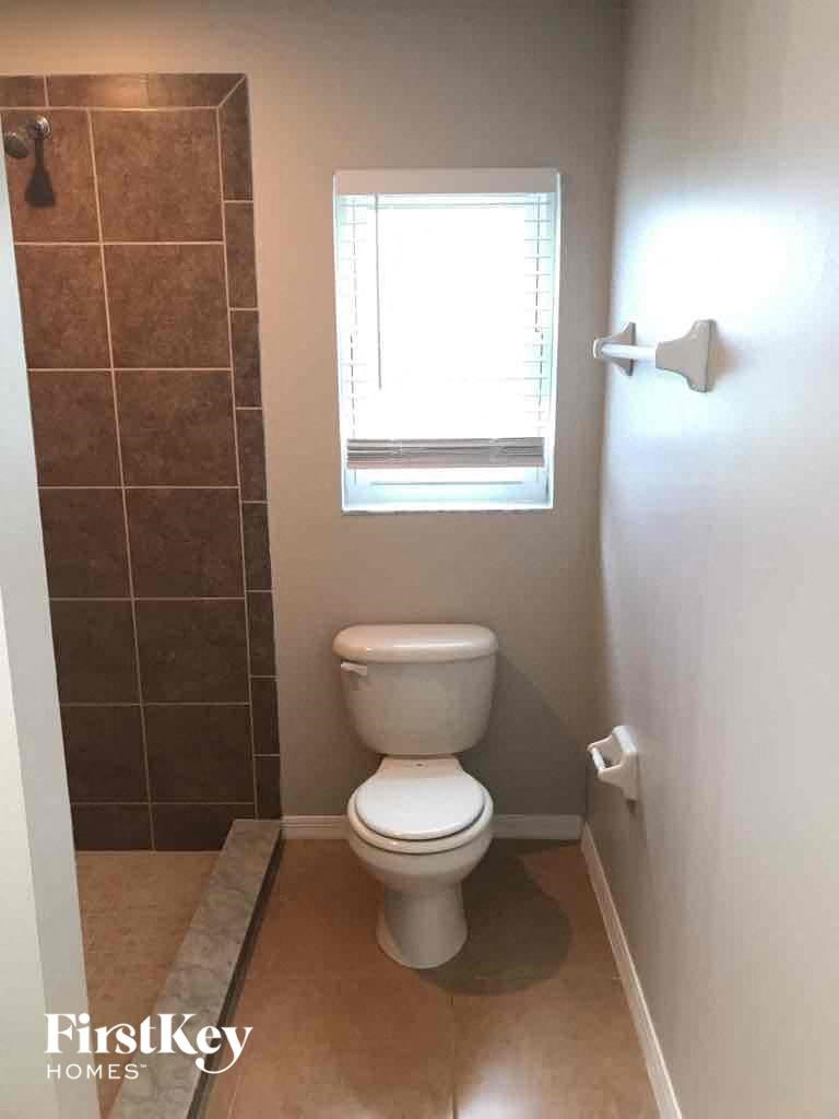 a small bathroom with a toilet and a window