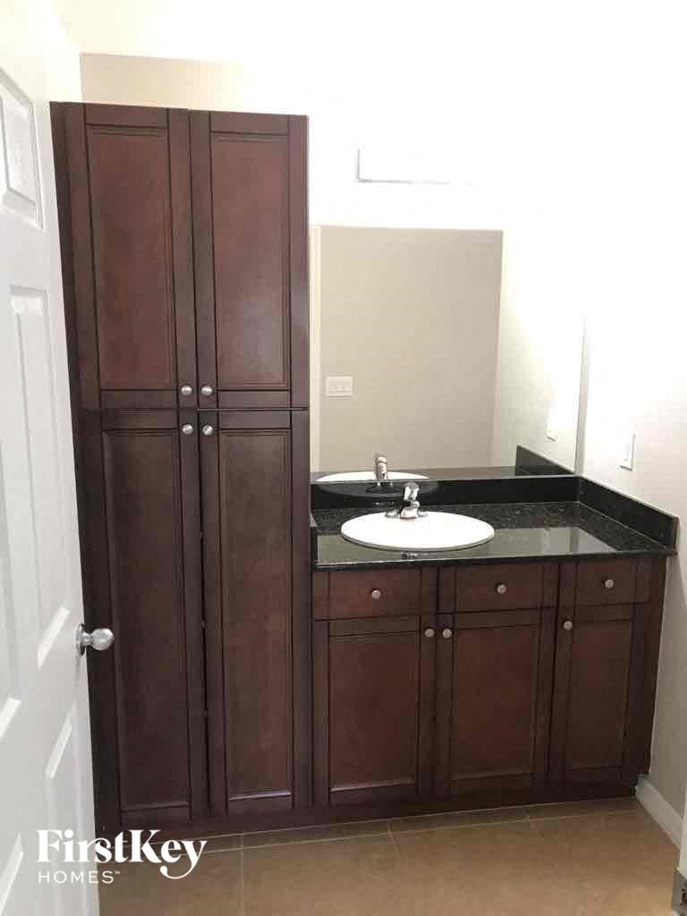 a small bathroom with a sink and cabinets