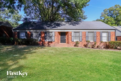 a brick house with a lawn in front of it