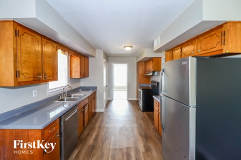 a kitchen with stainless steel appliances and wooden cabinets