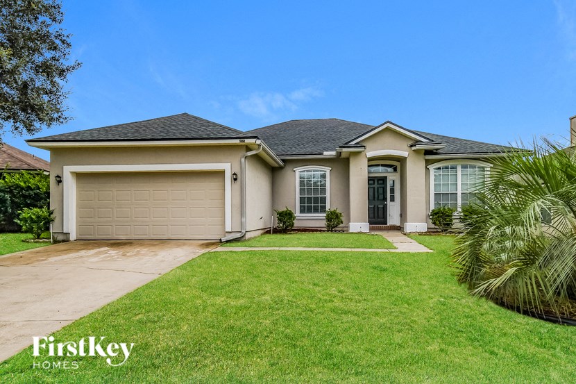 A house with a garage and a driveway is for sale.
