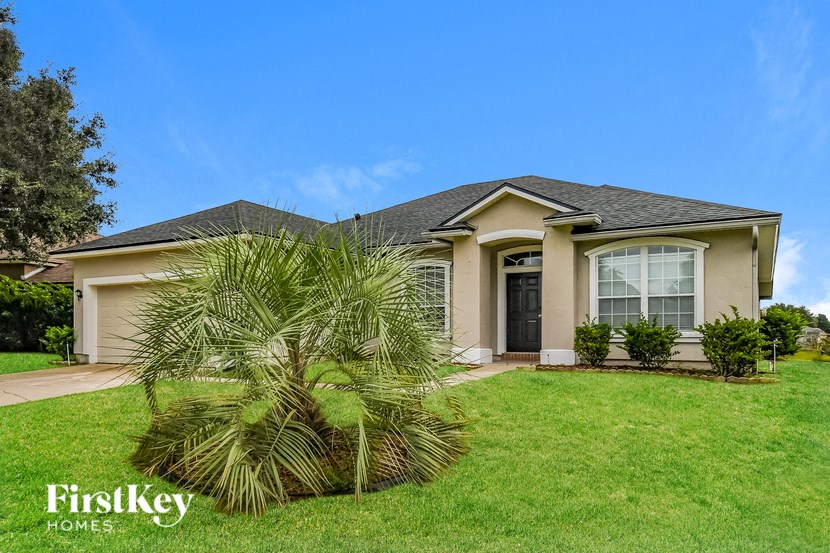 A house with a palm tree in front of it.