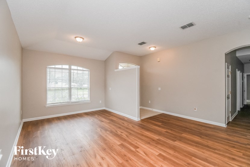 A room with wooden floors and a white door.