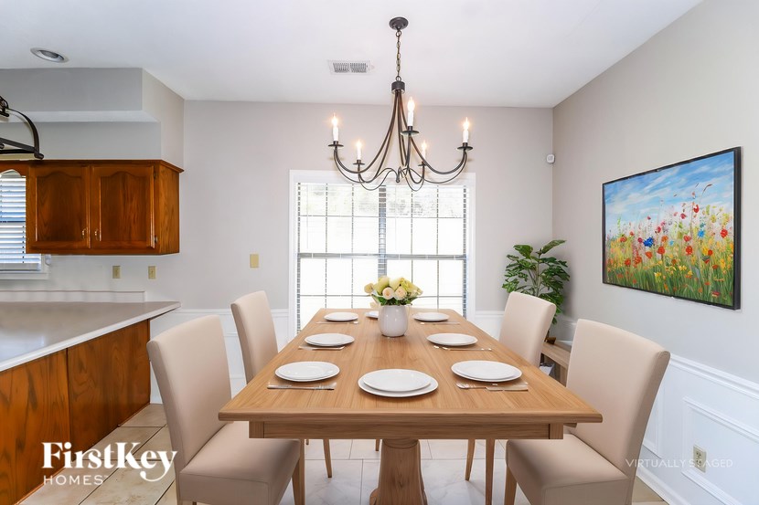 A dining room with a wooden table set for six.