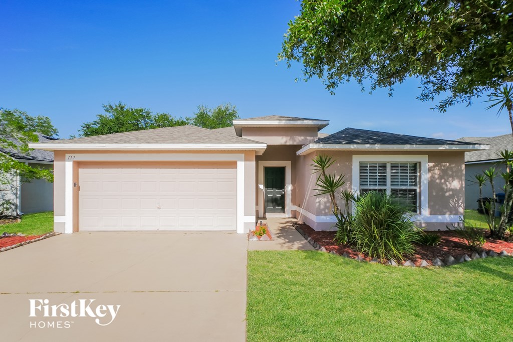 A house with a garage door and a sign that says "FirstKey Homes".