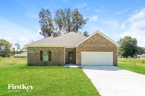 front view of a brick house with a white garage door