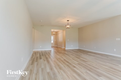 the living room and dining room are spacious and light wood flooring