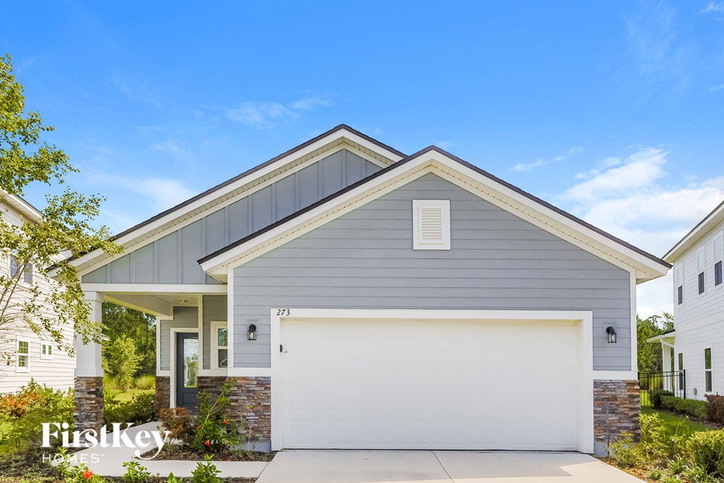 a gray house with a white garage door