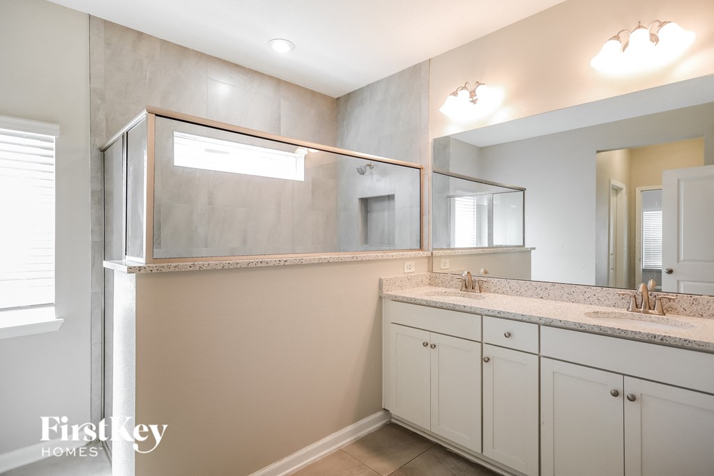 a bathroom with two sinks and a large mirror
