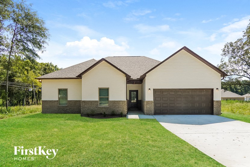 front view of a house with a lawn and a driveway
