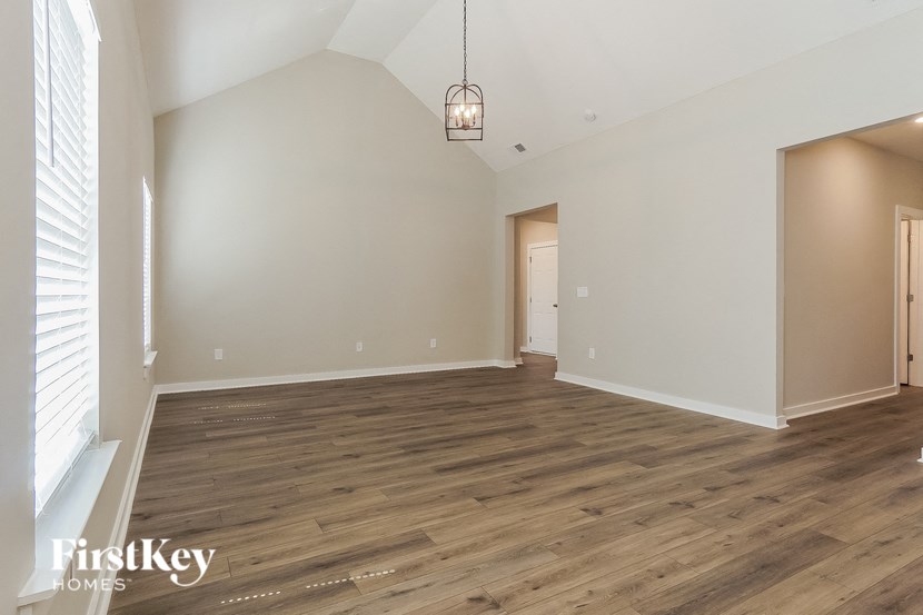 the living room and dining room with wood flooring