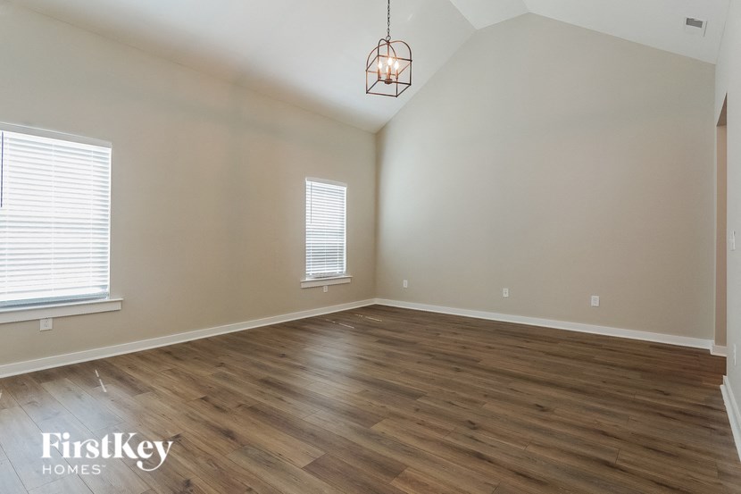 the living room with hardwood floors and a chandelier