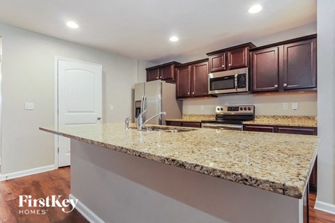 a kitchen with a granite counter top and stainless steel appliances