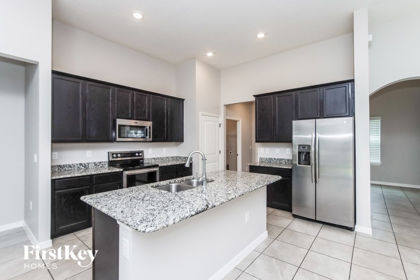 A kitchen with granite countertops and stainless steel appliances.