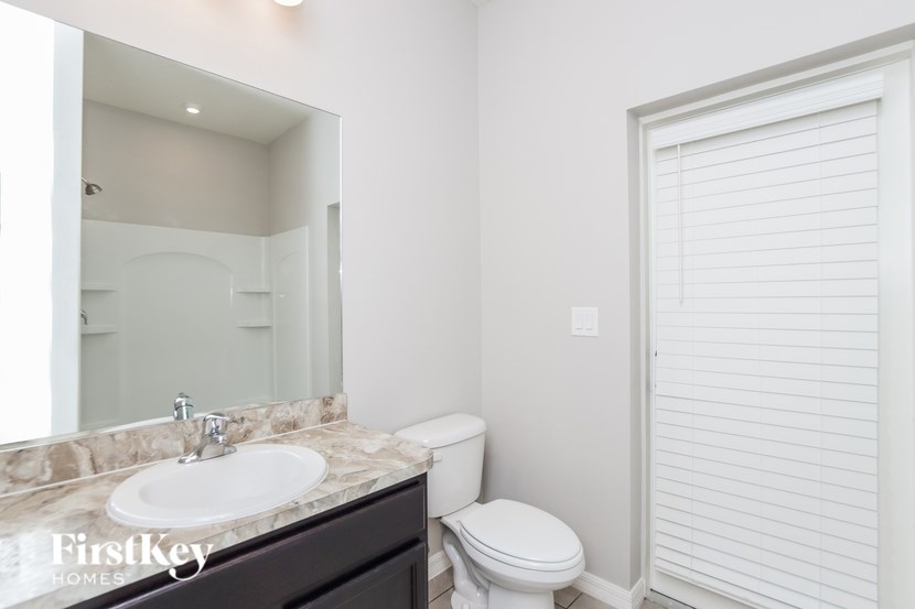 A white bathroom with a toilet and sink.