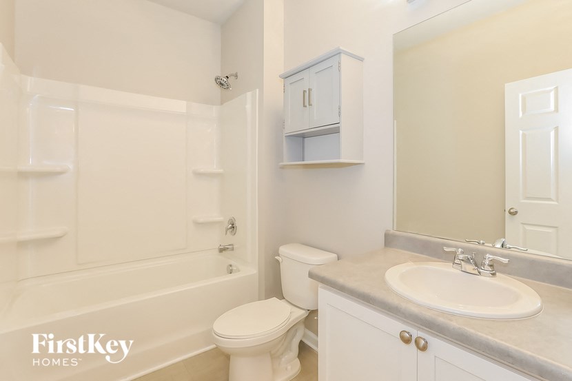 a bathroom with a sink toilet and a bath tub