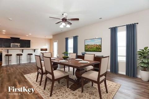 A dining room with a wooden table and chairs.