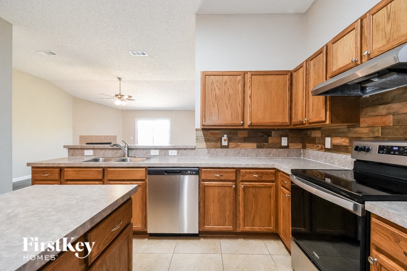 a kitchen with wooden cabinets and stainless steel appliances