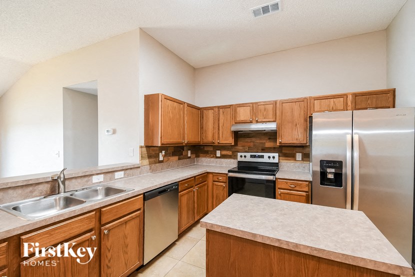 a kitchen with stainless steel appliances and wooden cabinets