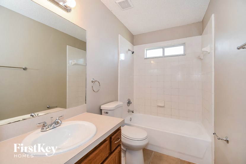 a bathroom with a shower toilet and sink and a tub