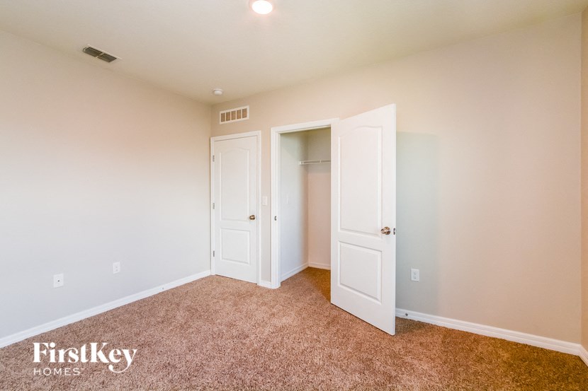 A room with two white doors and a carpeted floor.