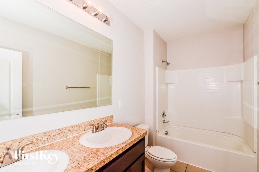 A bathroom with a sink, toilet, and bathtub.