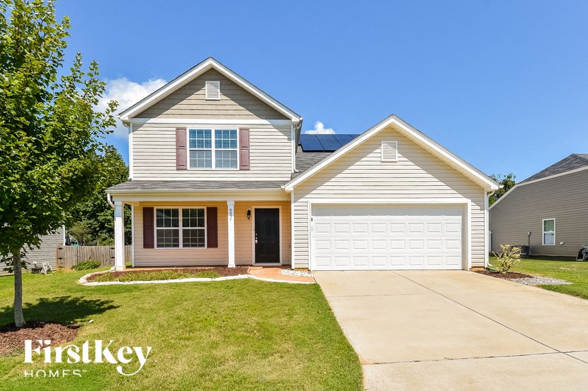 a suburban house with a driveway and a white garage door